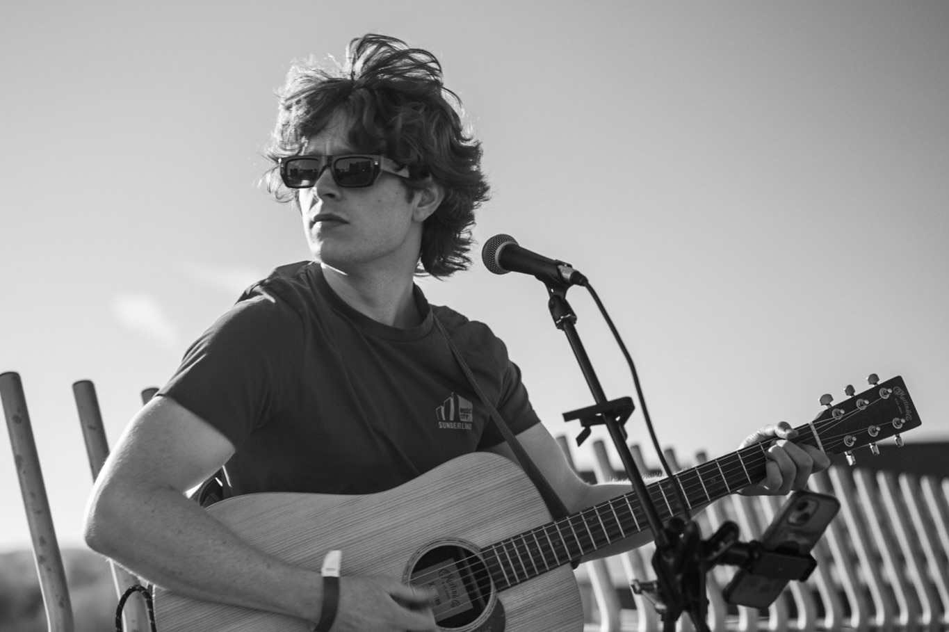 Acoustic singer and guitarist outdoors in black and white